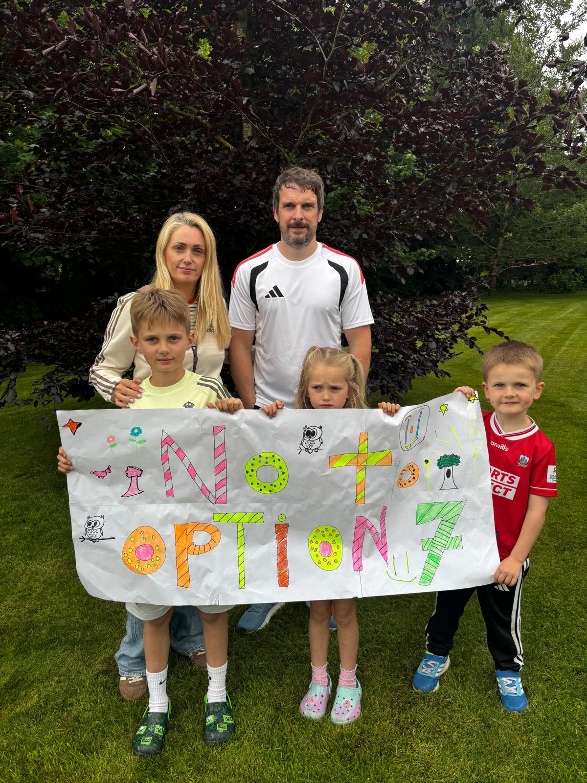 Family holding No to Option 7 banner